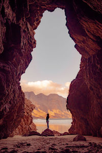 Scenic view of rock formation amidst sea against sky