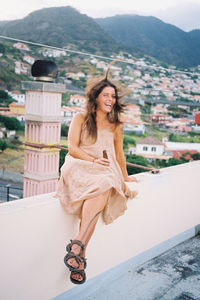 Portrait of smiling young woman in city