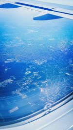 Cropped image of airplane wing over landscape