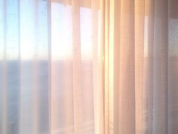 Close-up of white curtains on window