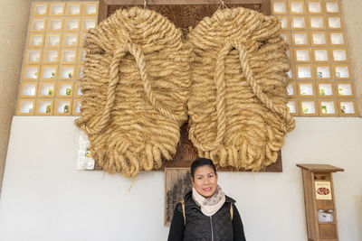 Portrait of smiling young woman standing in snow