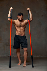 Portrait of young man exercising in gym