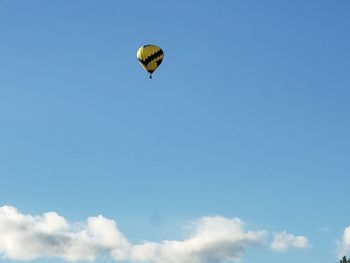 Low angle view of hot air balloons flying in sky