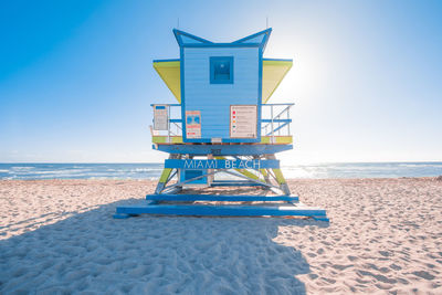 Lifeguard hut on beach against clear sky