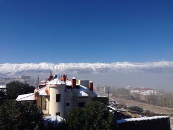 Buildings against sky during winter