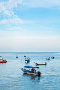 Boats in sea against sky