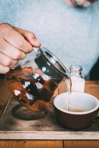 Close-up of hand pouring tea