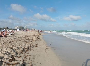 People at beach during sunny day