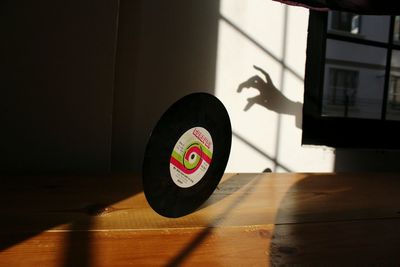 Shadow of person on hardwood floor by wall