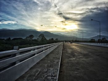 Empty road against cloudy sky