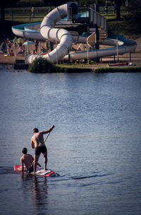 People paddleboarding in water park