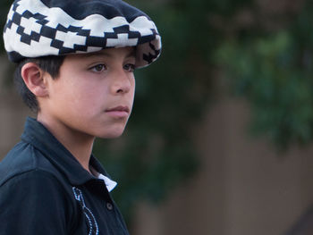 Portrait of boy looking away outdoors