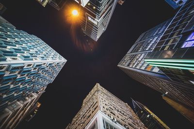 Low angle view of skyscrapers lit up at night