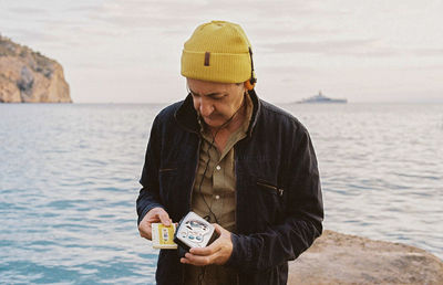 Portrait of man standing against sea
