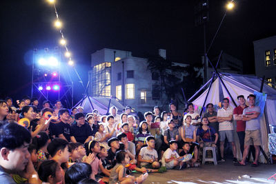 Group of people at street in city at night