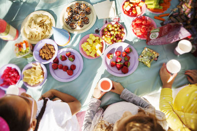 Overhead view of children eating at table in party