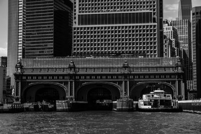 Bridge over river against buildings