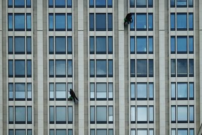 Window washers working at modern building