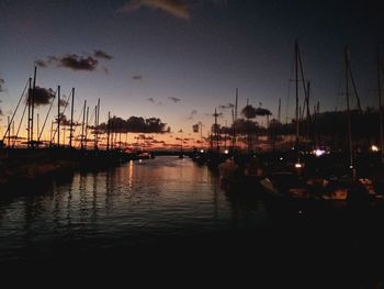 Sailboats in marina at sunset