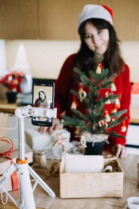 Portrait of young woman sitting on table