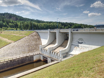 View of dam on bridge against sky