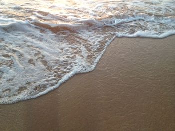 High angle view of waves rushing towards shore