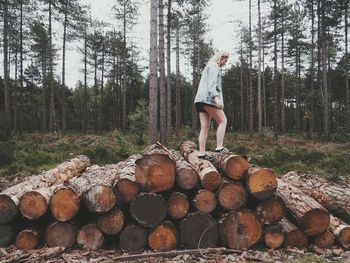 Woman standing on rock in forest