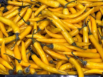 Full frame shot of yellow chili peppers for sale at market stall