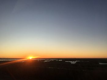 Scenic view of sea against clear sky during sunset