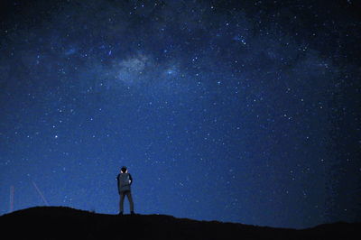 Man standing against sky at night
