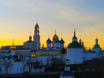 View of buildings in city against sky during sunset