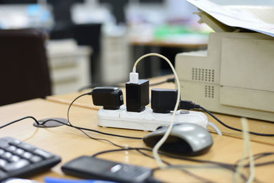 Close-up of electrical equipment on desk in office