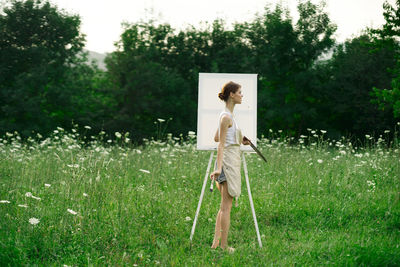 Full length of woman standing on field