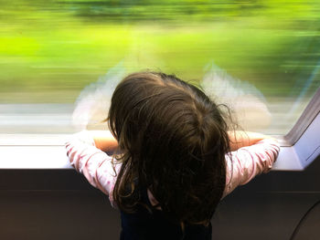 Rear view of woman in train