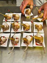 High angle view of hand holding food on table