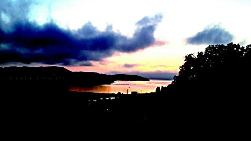 Silhouette of landscape against cloudy sky