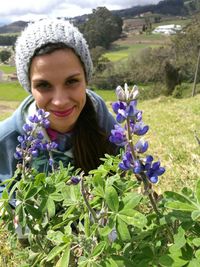 Portrait of a smiling young woman on purple flowering plants