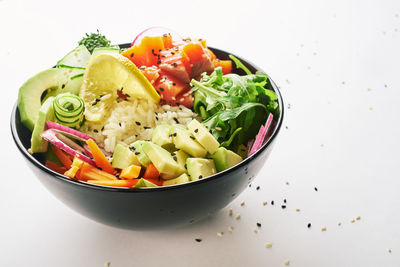Close-up of chopped vegetables in bowl against white background