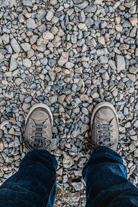 Low section of man standing on stones