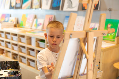 Boy painting at classroom