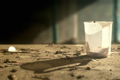 Old plastic mug with a hard shadow