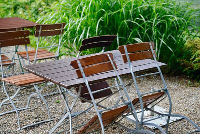 Empty chairs and table on field