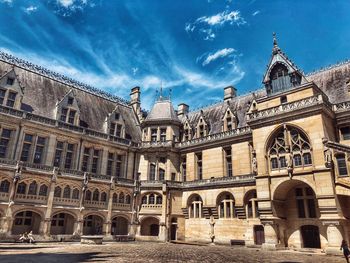 Low angle view of historical building against blue sky