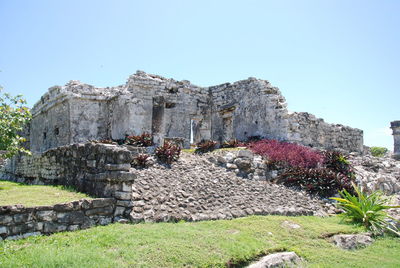 Low angle view of old ruins against clear blue sky