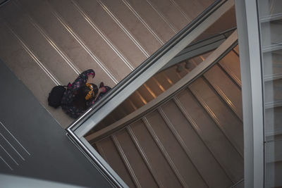 High angle view of man sitting on steps