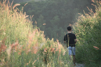 Rear view of man standing on field