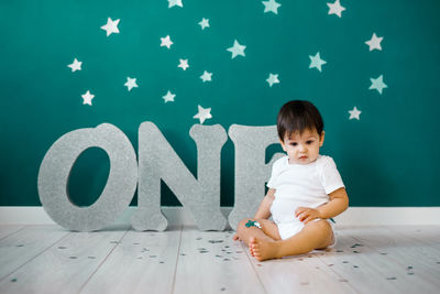 Full length of boy sitting on floor