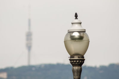 Close-up of street light against building