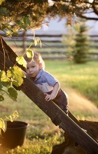 Portrait of young woman sitting on field