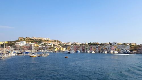 View of town by sea against clear sky